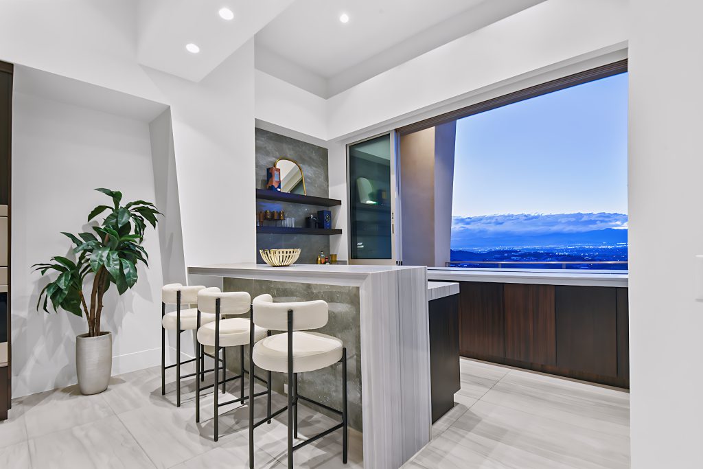 Modern Summerlin staged home bar with sleek furniture and city view. | Utopia Home Luxury Home Staging & Design